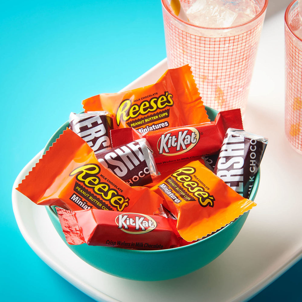 HERSHEY'S mini bar held in hand demonstrating portion size and sharing ease