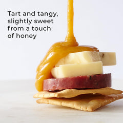 Hickory Farms spread on cracker next to cheese, adds fruity sweetness