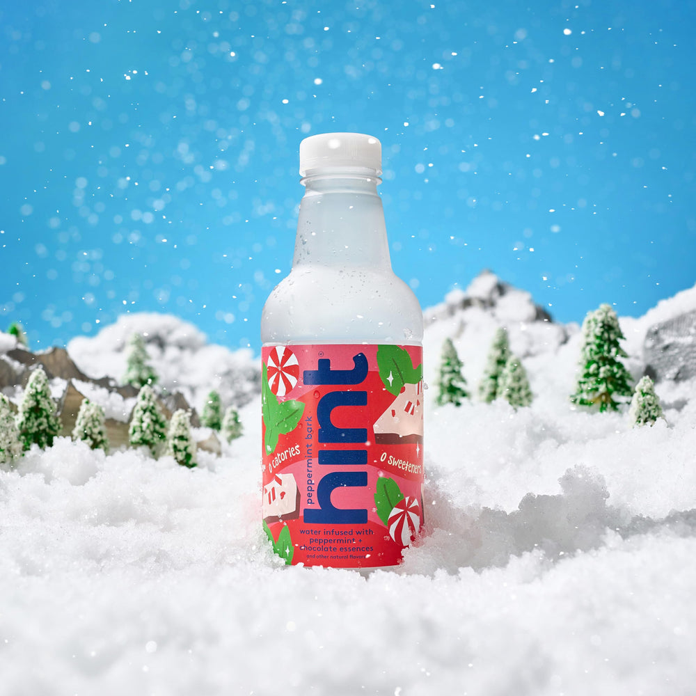 Hint bottle on a cozy table setting to show lifestyle appeal and seasonal mint flavor