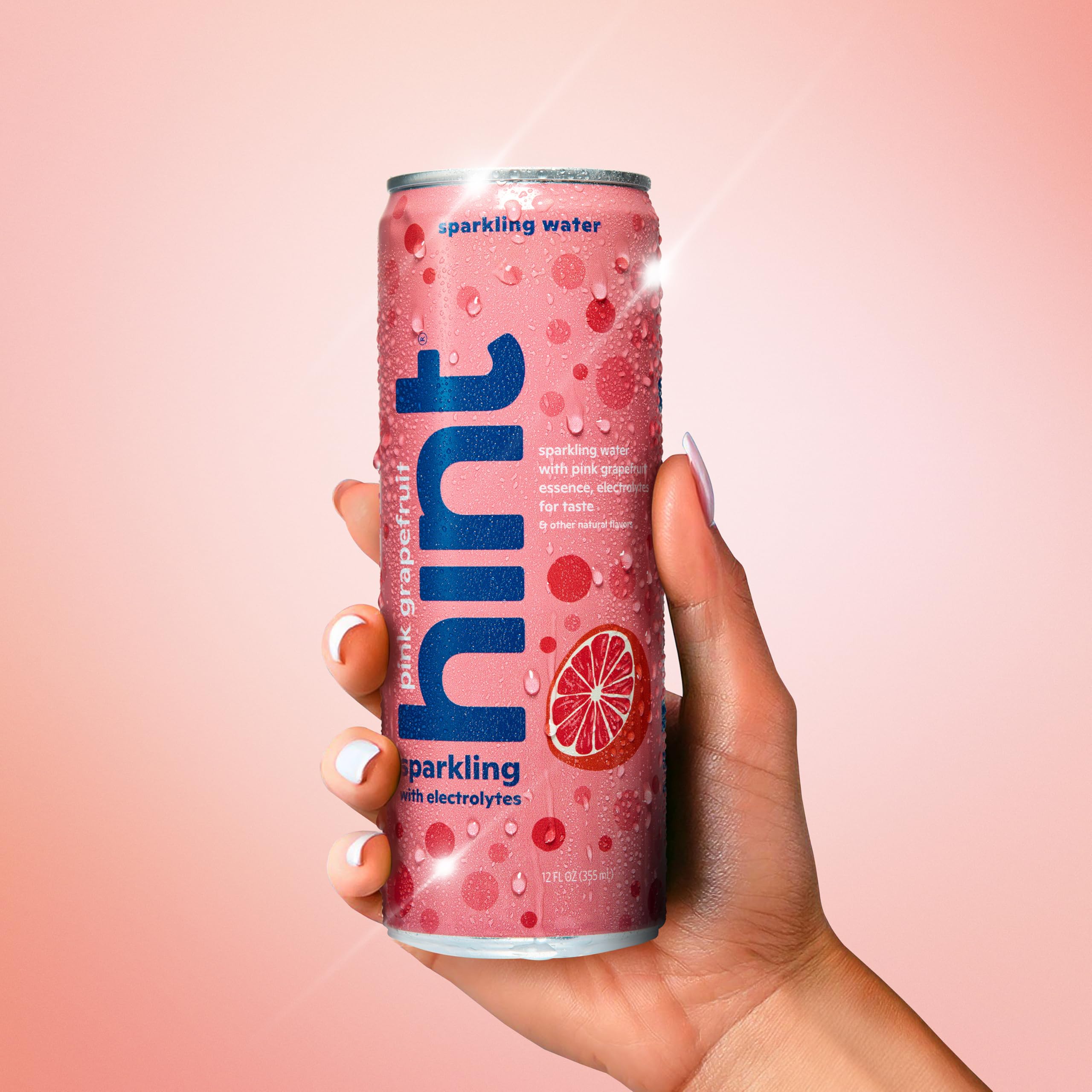 Hint pink grapefruit pouring into glass with fizz showcasing enjoyable sparkling texture
