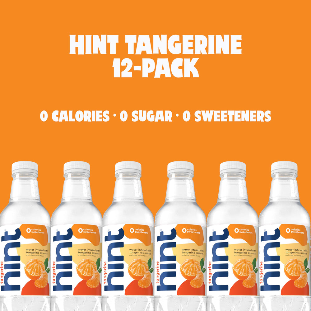 Hand holding Hint tangerine bottle demonstrating portable hydration benefit