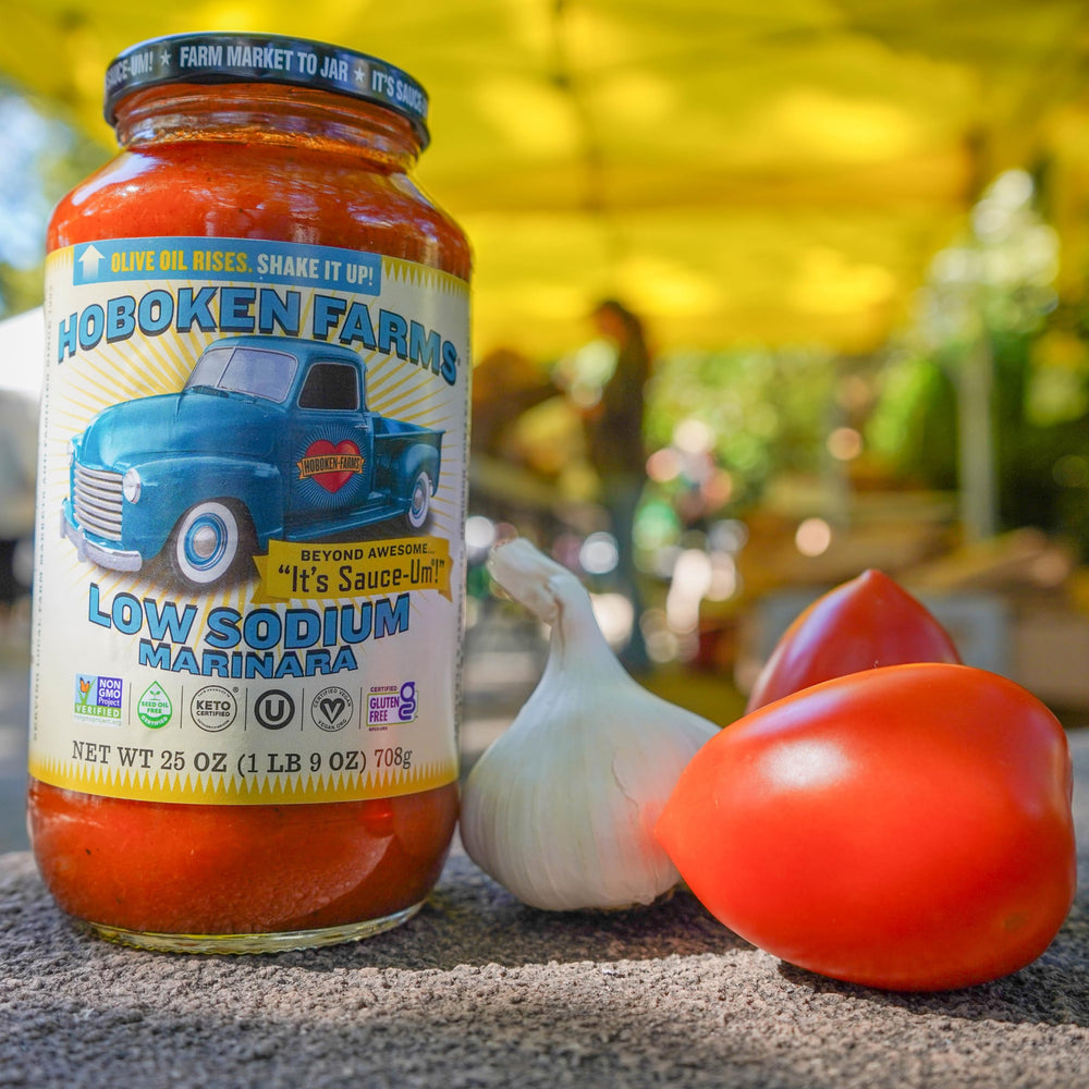 Hoboken Farms pouring sauce over pasta for a quick meal