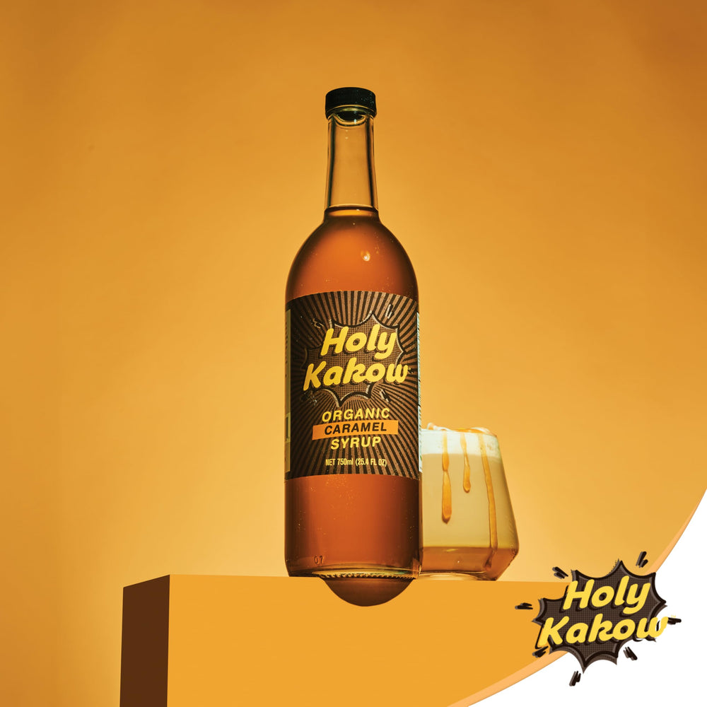 Holy Kakow bottle in hand for scale showing 750ml size and craft small-batch appeal