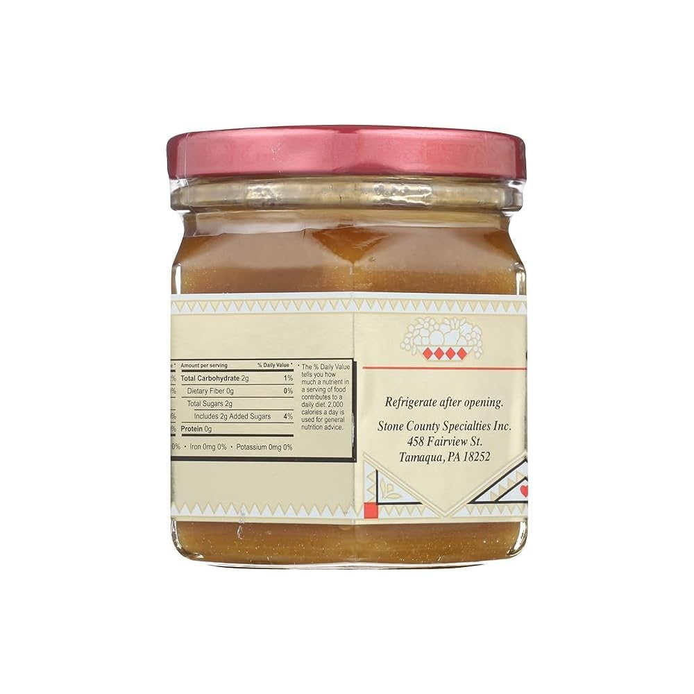 Honeycup jar beside spoon and napkin for scale, compact 8oz convenience