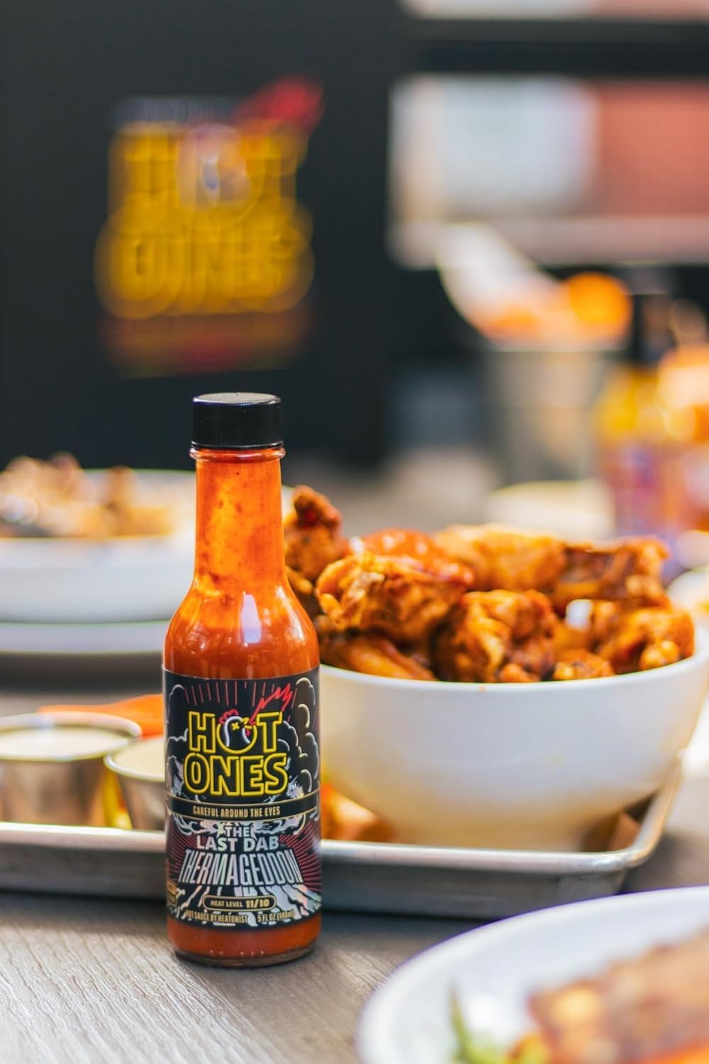 Hot Ones trio held in hand for scale to show compact 5 fl oz bottles