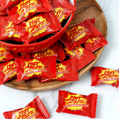 THE HAMPTON CANDY COMPANY hand holding Hot Zotz to show size benefit