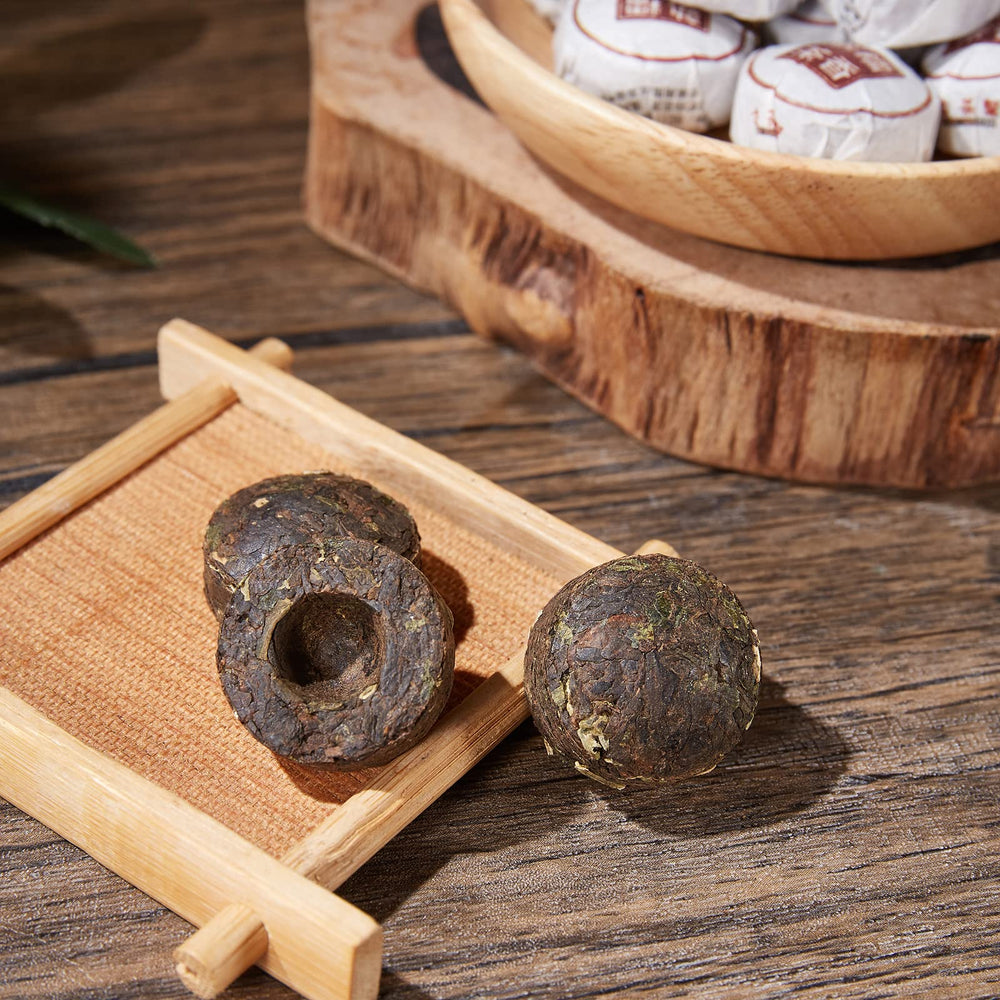 HUAYING single mini tea cake close-up showing pressed shape for single-serving convenience