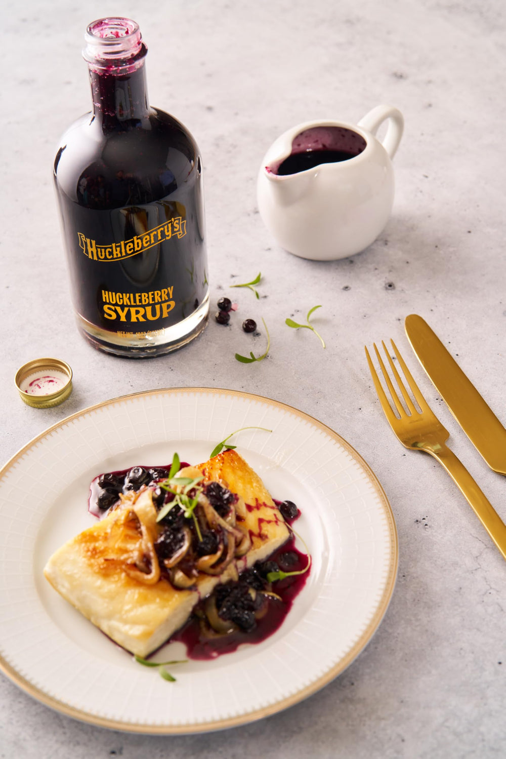 HUCKLEBERRY'S BREAKFAST · LUNCH bottle next to measuring spoon for size clarity