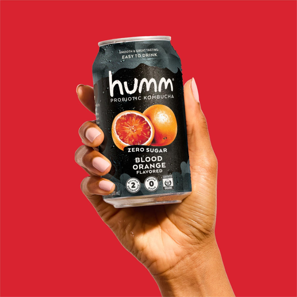 Humm can held in hand for size comparison and portable convenience