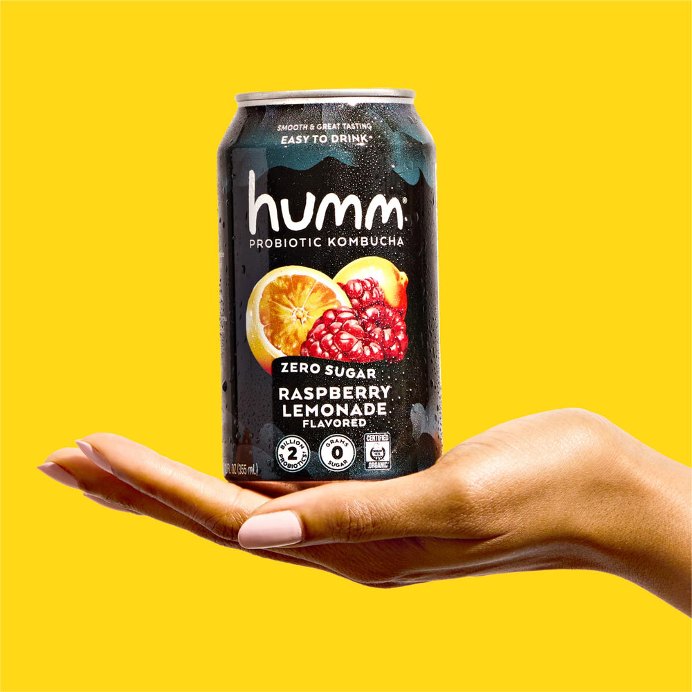 Humm can in hand to show 12oz size and portable convenience