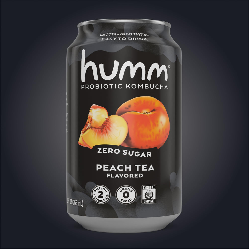 Humm cans on picnic blanket with fruit, lifestyle scene for on-the-go enjoyment
