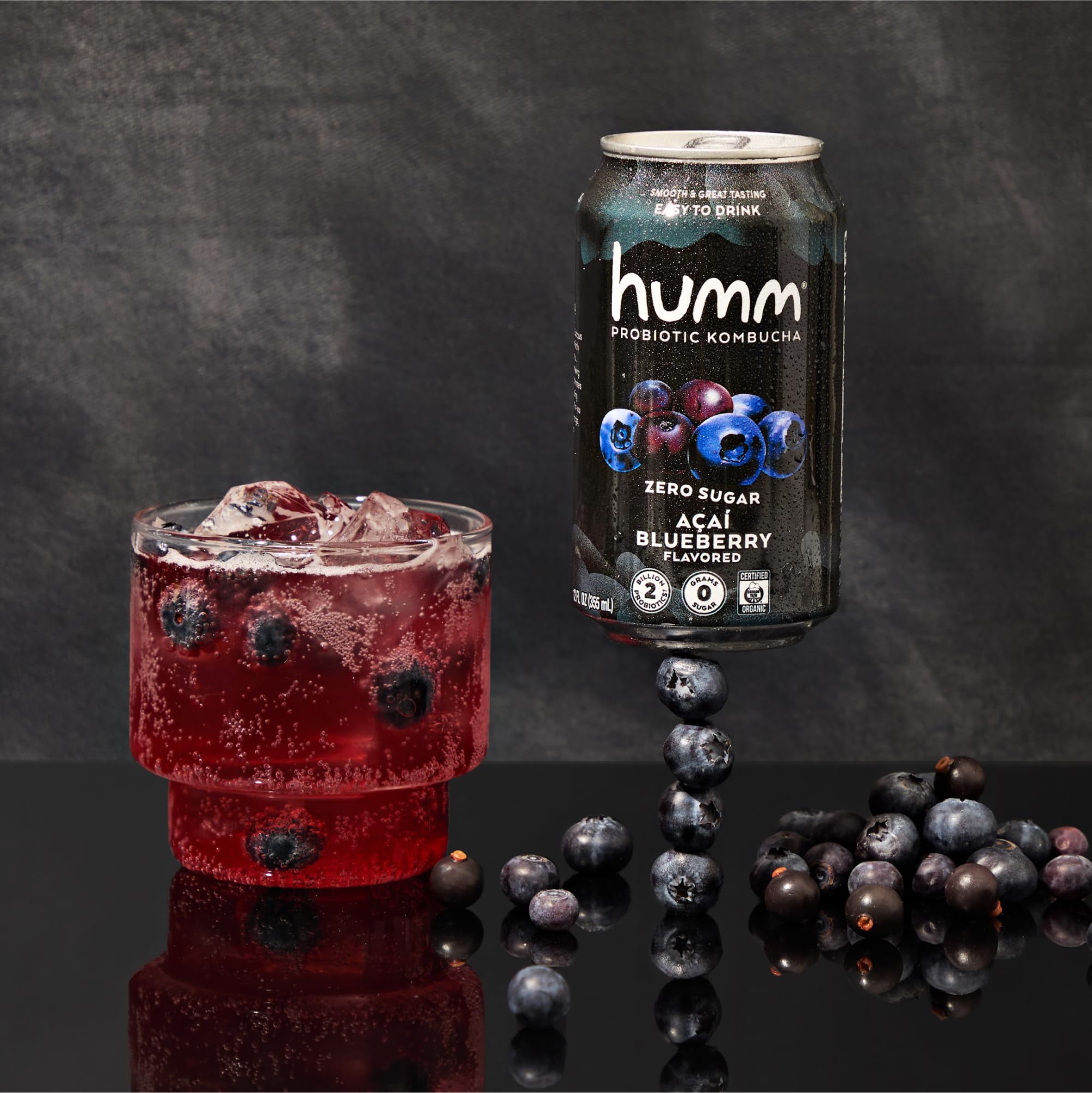 Humm cans in an outdoor picnic scene showing shelf-stable portability and on-the-go benefit