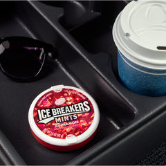 Ice Breakers tin held in hand demonstrating pocketable size and easy access