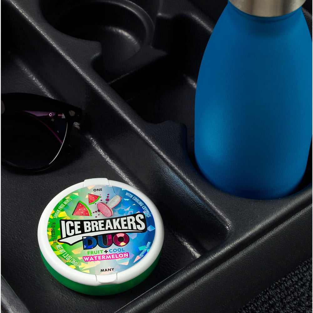 Ice Breakers Duo mint tin in hand illustrating pocket-sized portability benefit