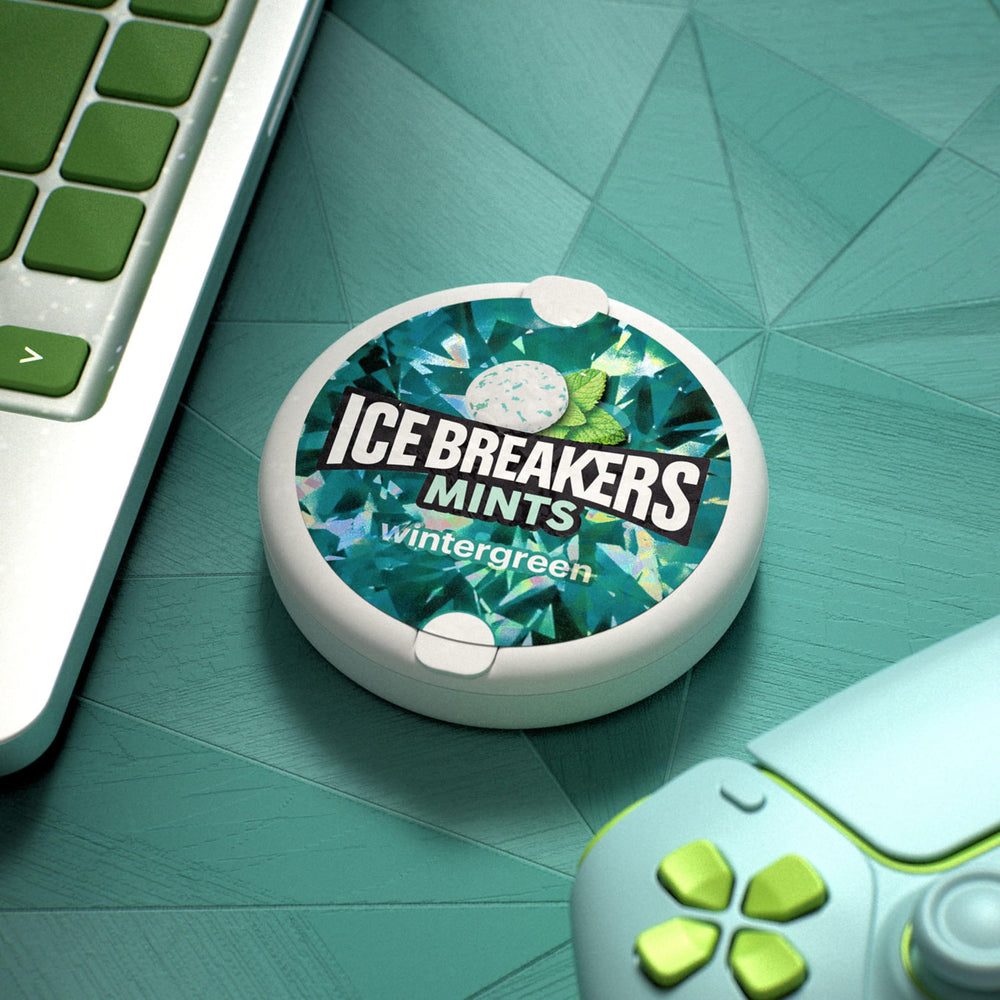 Ice Breakers tin peeking from a pocket highlighting portable freshness convenience