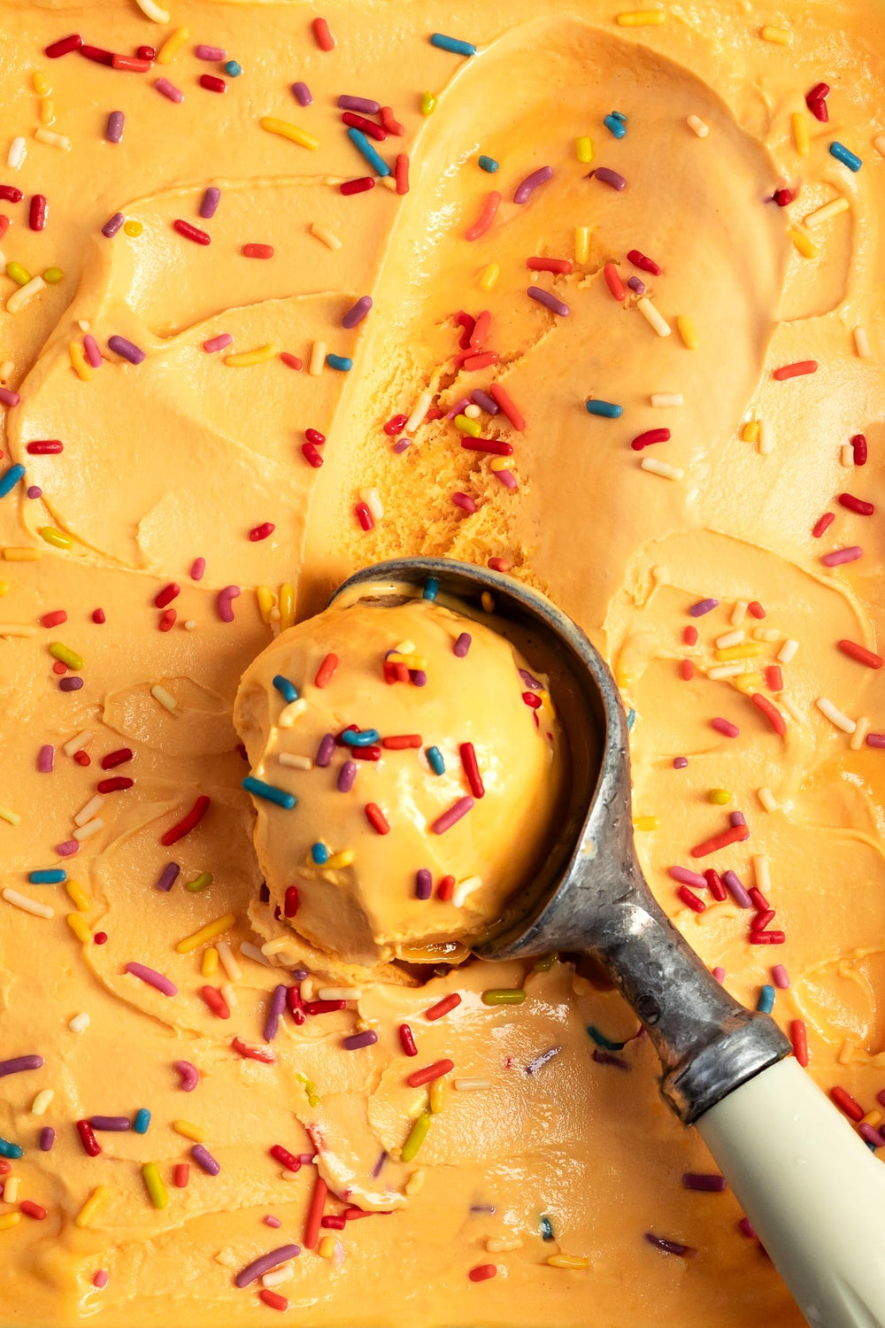 Ice cream scoop topped with India Tree sprinkles showing appealing finishing touch