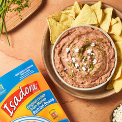 Isadora open pouch with creamy refried beans visible, quick microwave meal benefit