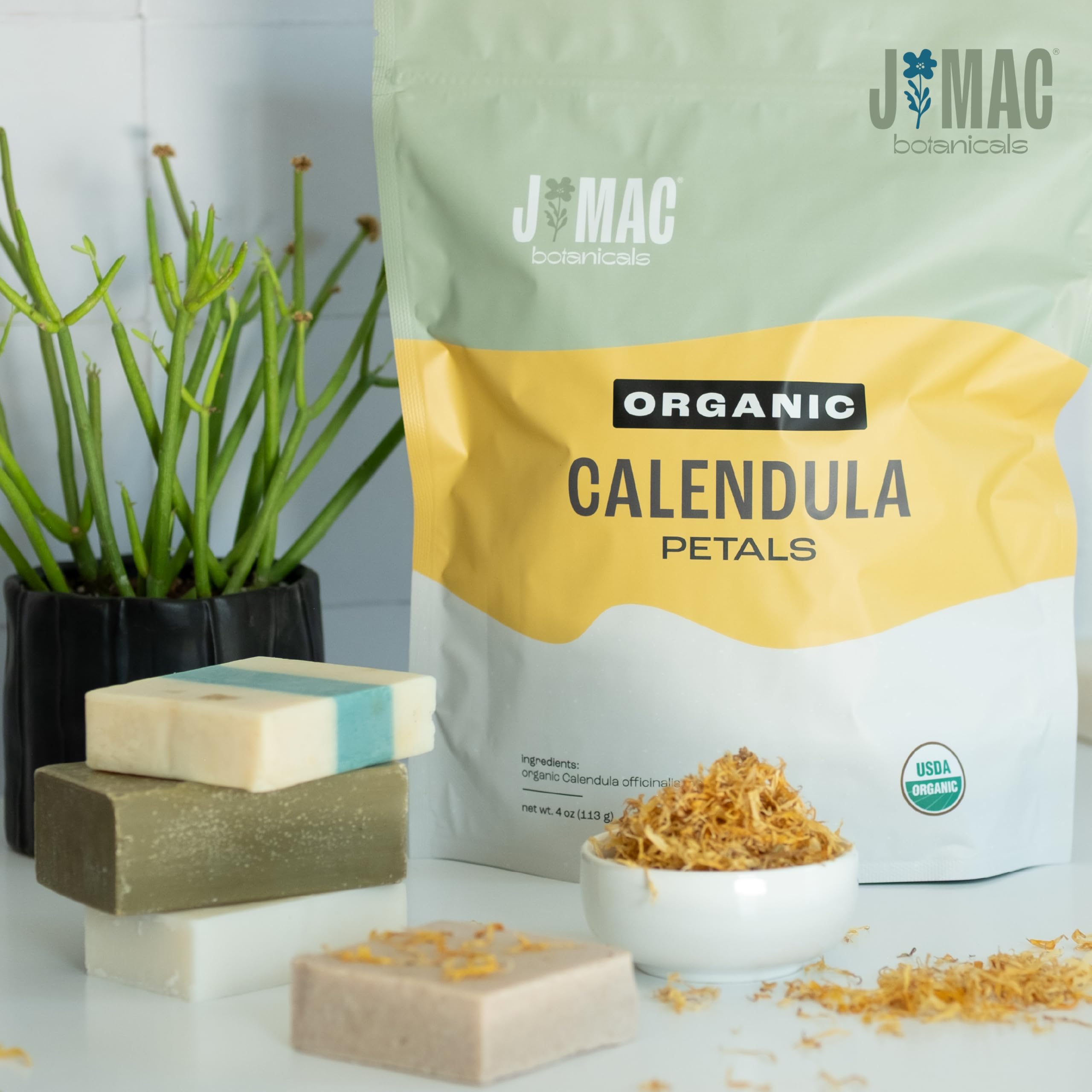 J MAC BOTANICALS dried calendula petals stored in glass jar for easy access and visual appeal