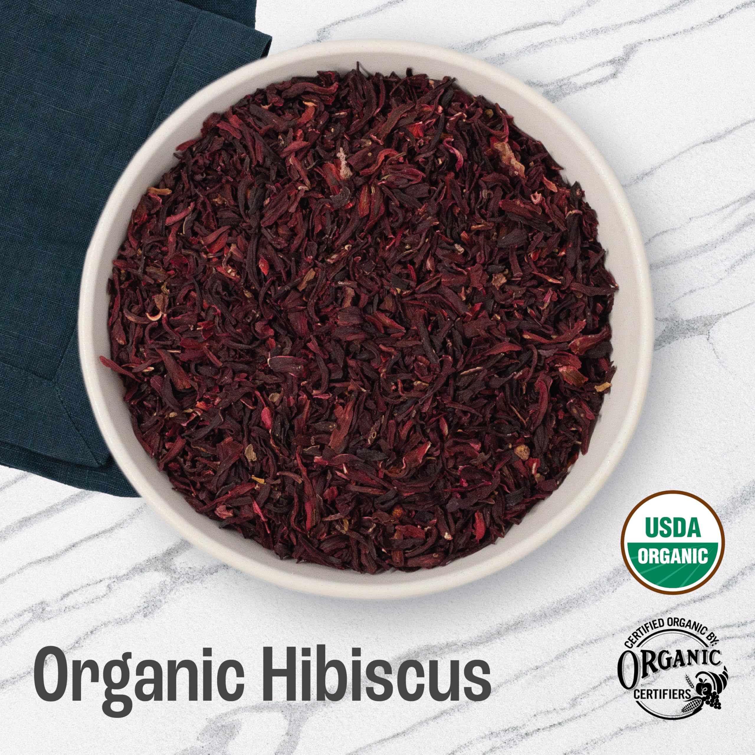 J MAC BOTANICALS close-up of cut and sifted hibiscus petals highlighting rich color and fresh texture