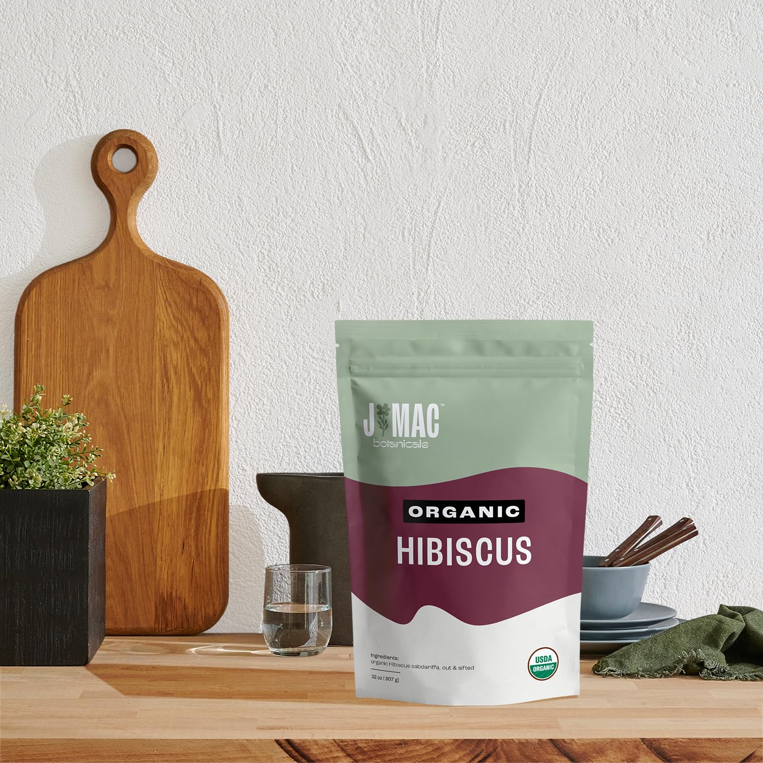 J MAC BOTANICALS tea sachet with brewed cup illustrating convenient single-serve steeping benefit