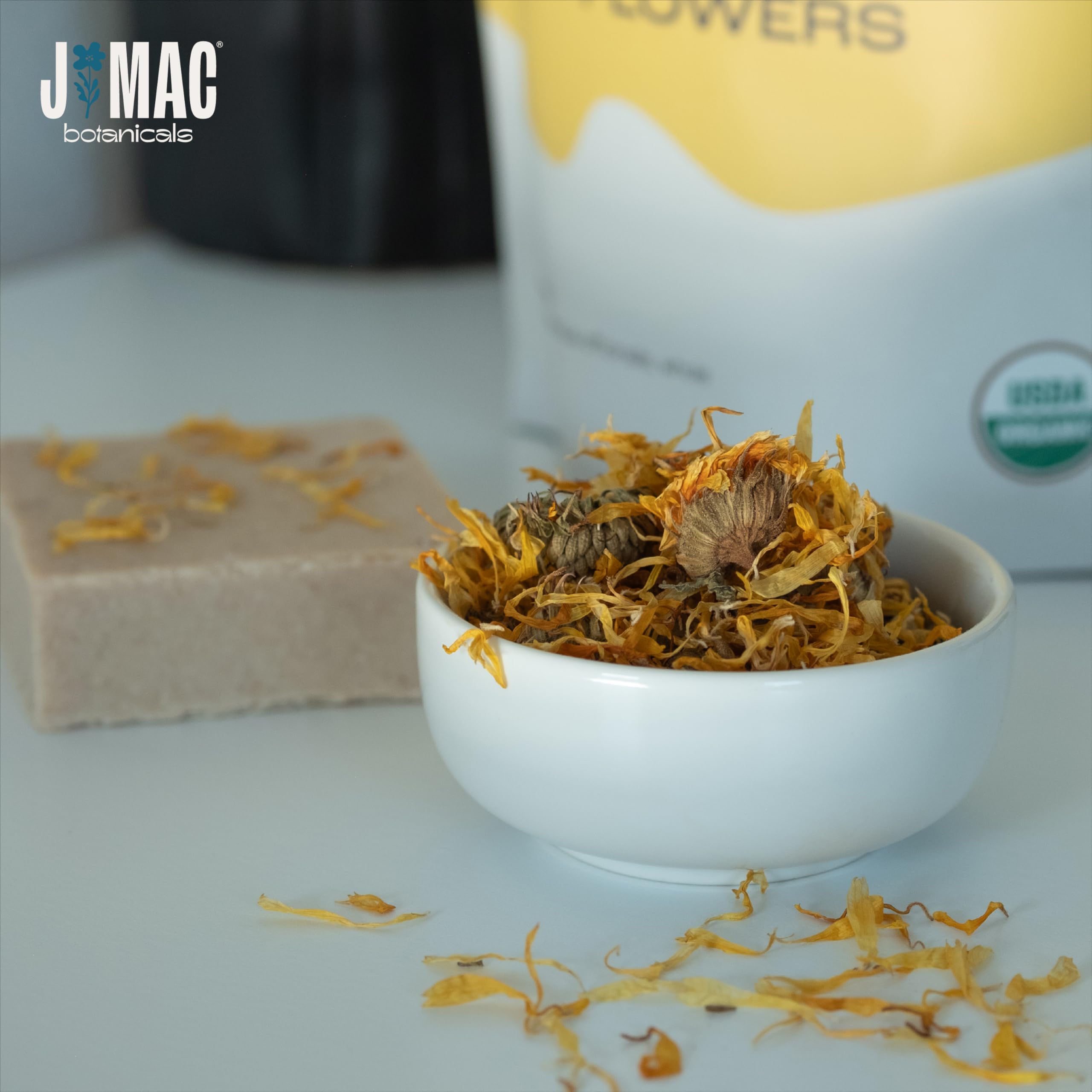 J Mac Botanicals salve and soap display using calendula for cosmetic craft inspiration and appeal