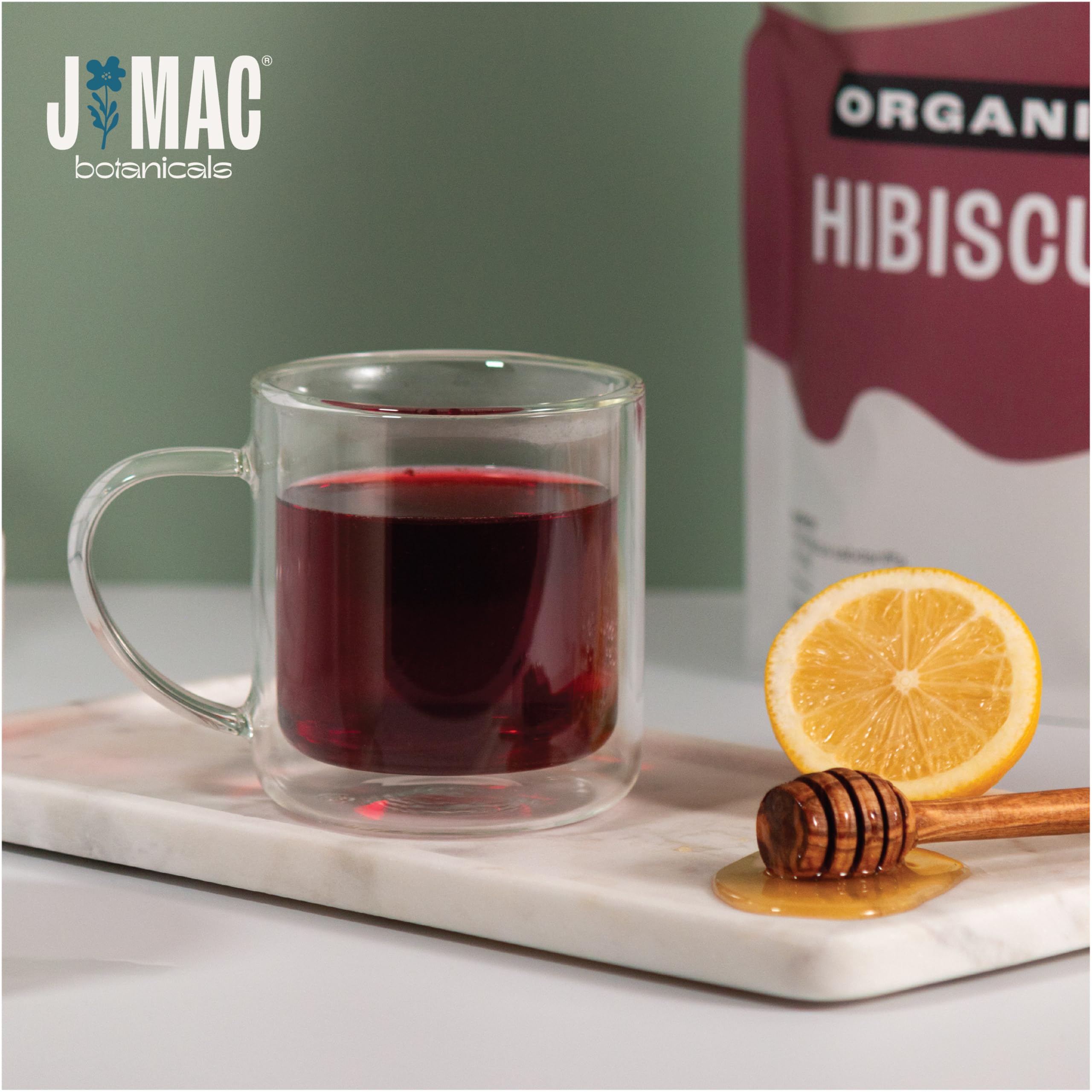 J MAC BOTANICALS hibiscus tea in a mug showing vibrant red brew and inviting serving idea