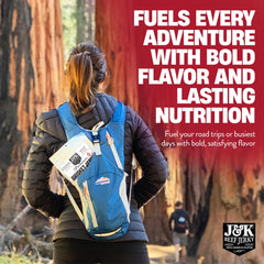 Person holding a J&K brisket piece as a quick snack, emphasizing on-the-go protein