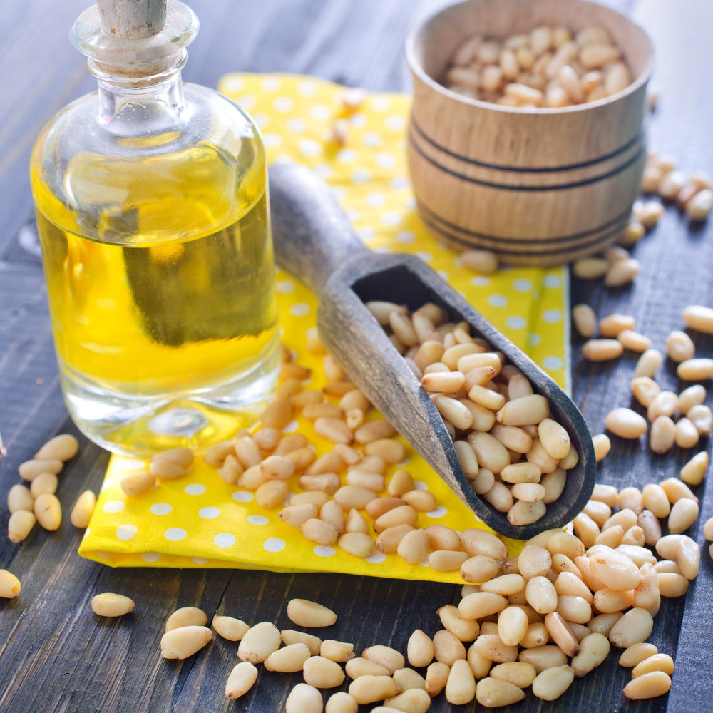 Jaybee's pine nuts next to measuring cup to show 2 lb quantity scale