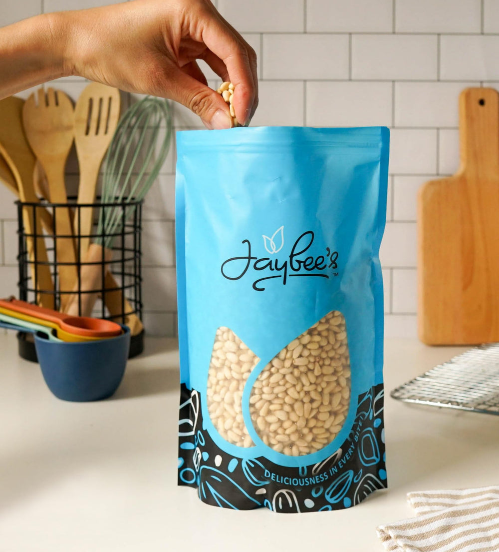 Jaybee's pine nuts toasted on spoon to show enhanced flavor benefit