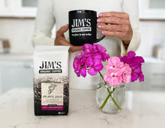 Jim's Organic Coffee brewed cup in hand demonstrating approachable, mellow flavor