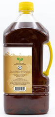 Jiva Organics sesame oil pouring into a hot pan for sautéing with even heat