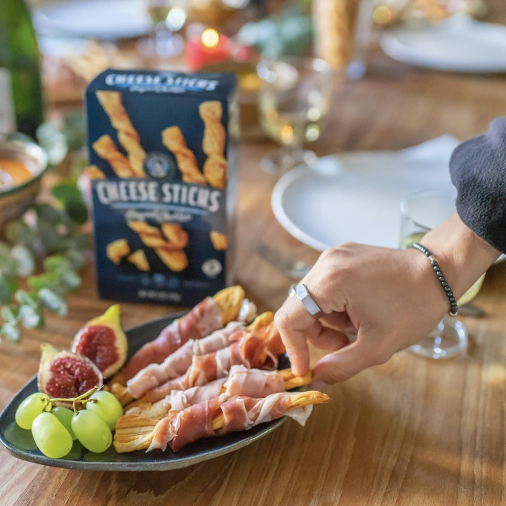 John Wm. Macy's CheeseSticks beside dip showing convenient party serving