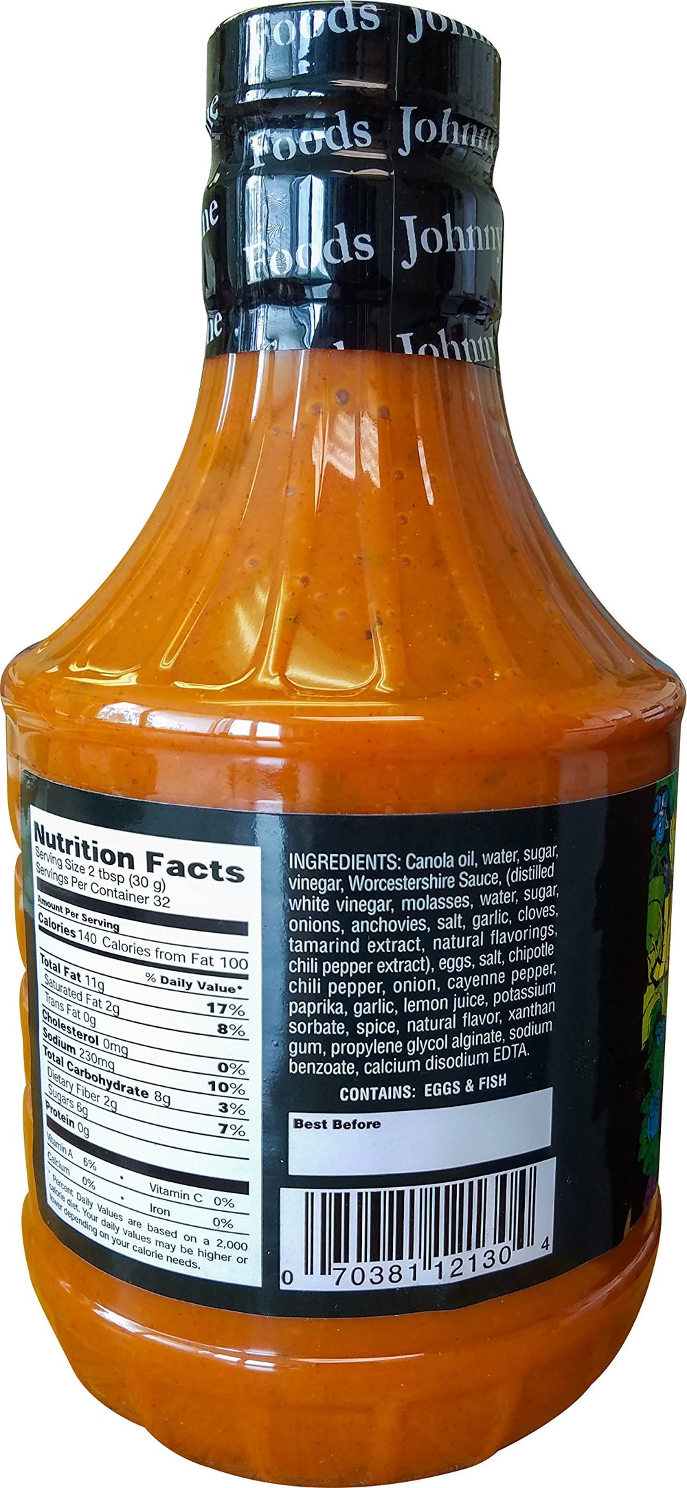 Johnny's dressing being poured onto cooked wings delivering sticky zesty flavor