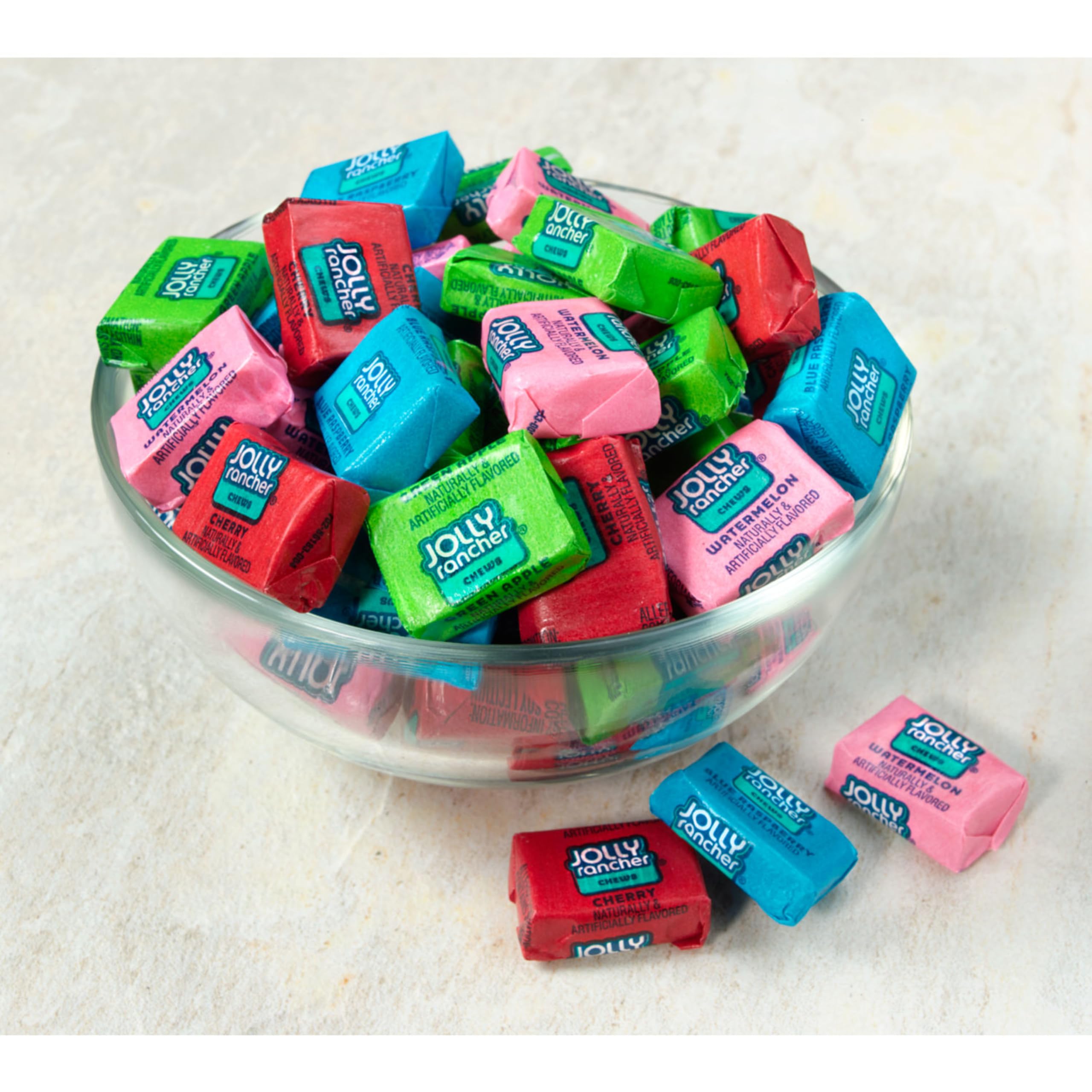 Hand holding a Jolly Rancher chew illustrating portable size and easy snacking