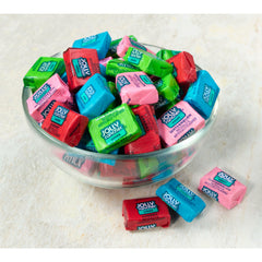 Hand holding a Jolly Rancher chew illustrating portable size and easy snacking