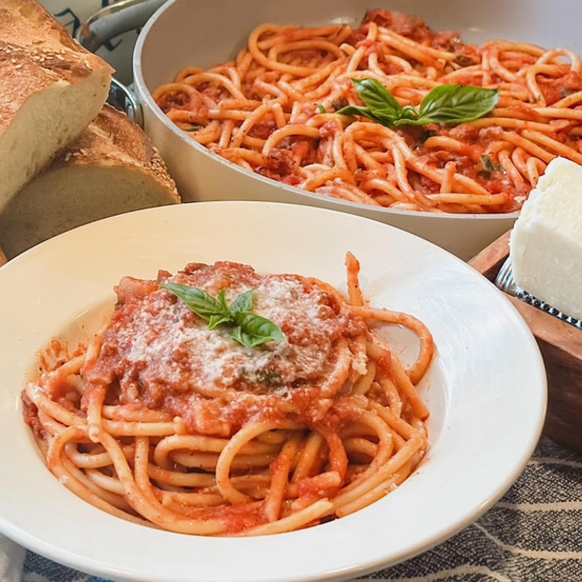 Jovial cooked bucatini plated with tomato sauce showcasing hearty bite