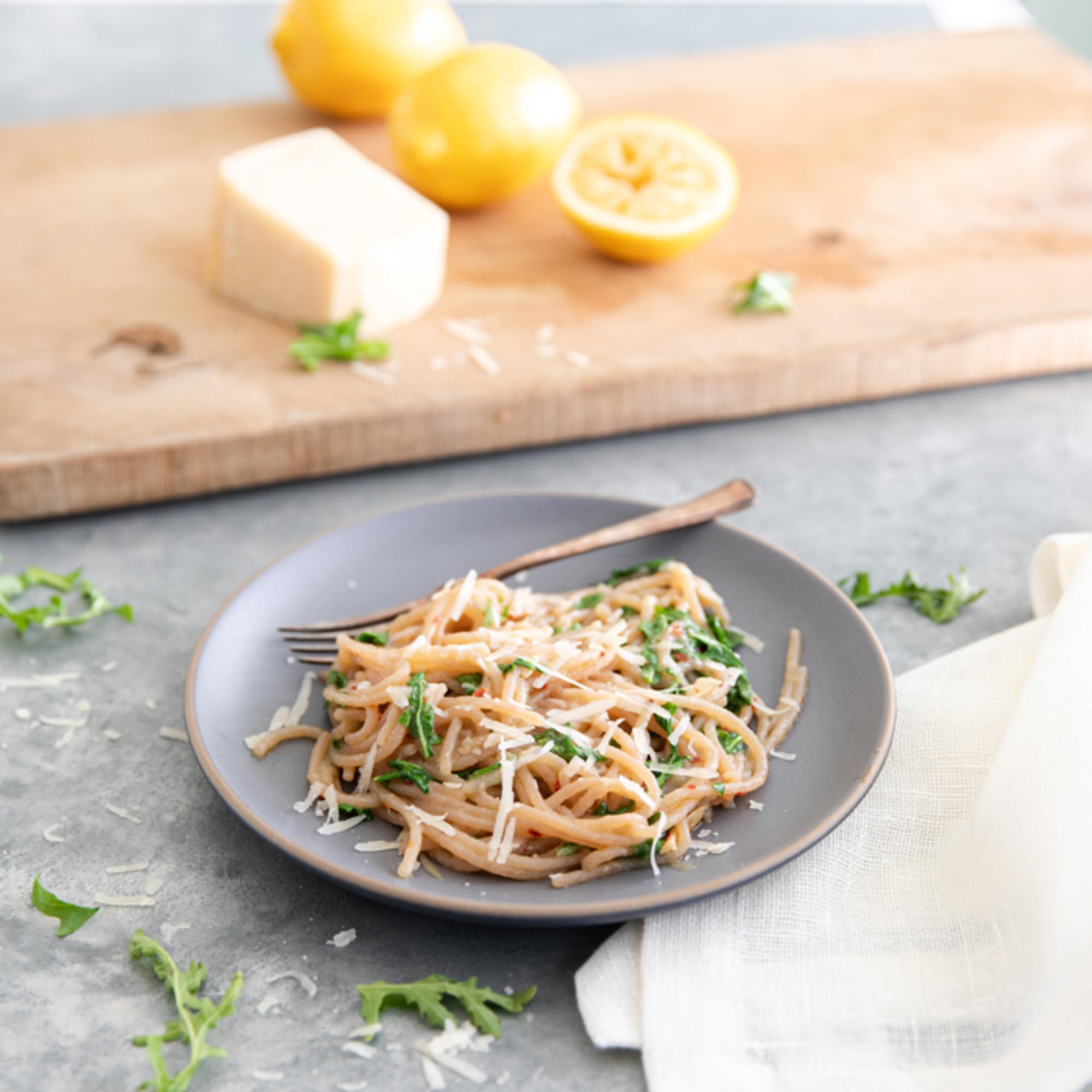 Jovial cooked cassava spaghetti plated with tomato sauce and fresh basil