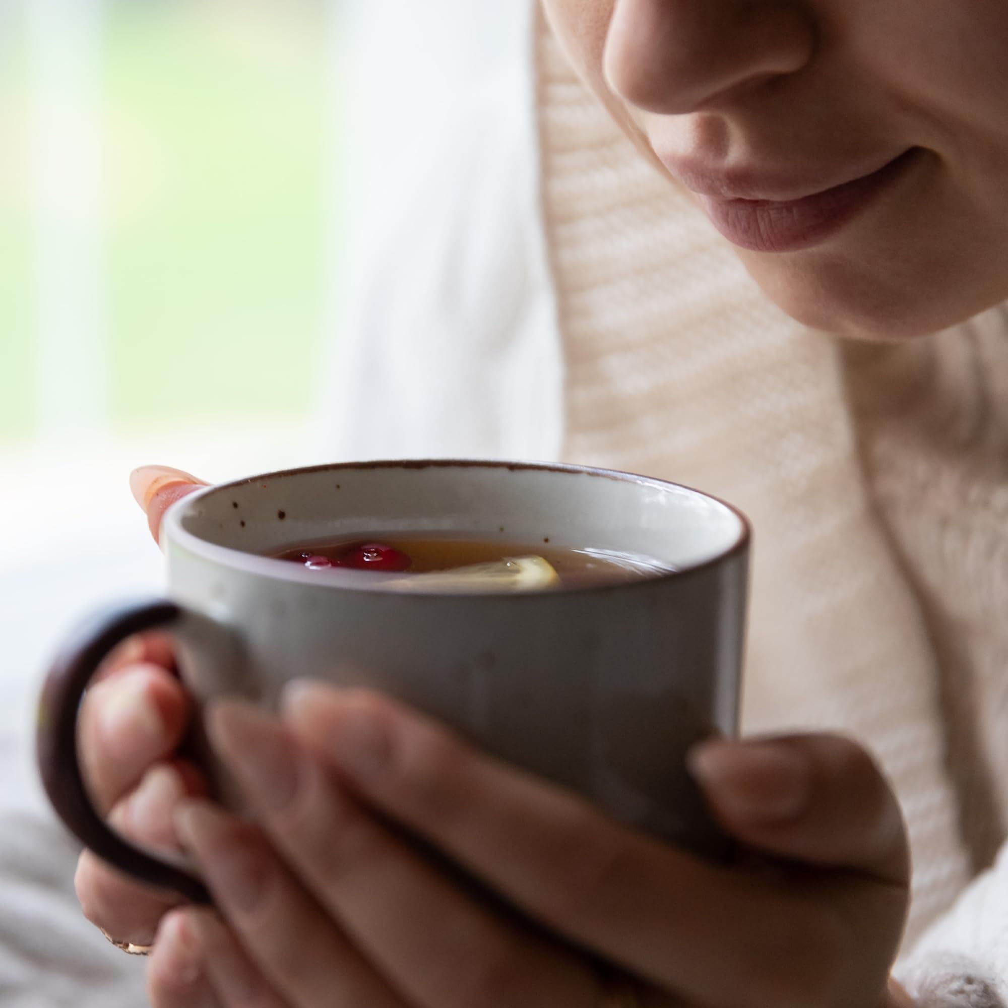 Brewed sarsaparilla tea poured into cup with Jovvily root nearby, demonstrating easy home infusion