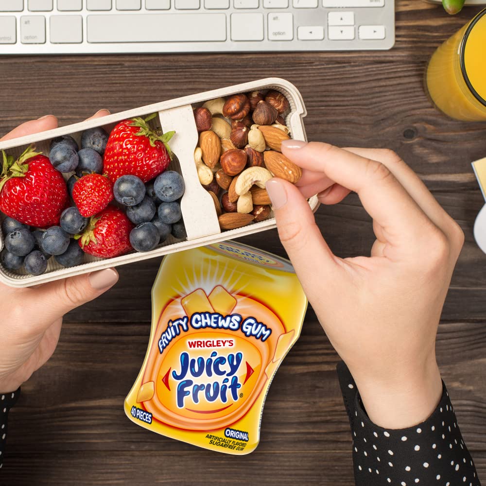 JUICY FRUIT bottle held in hand showing scale and portable, on-the-go convenience