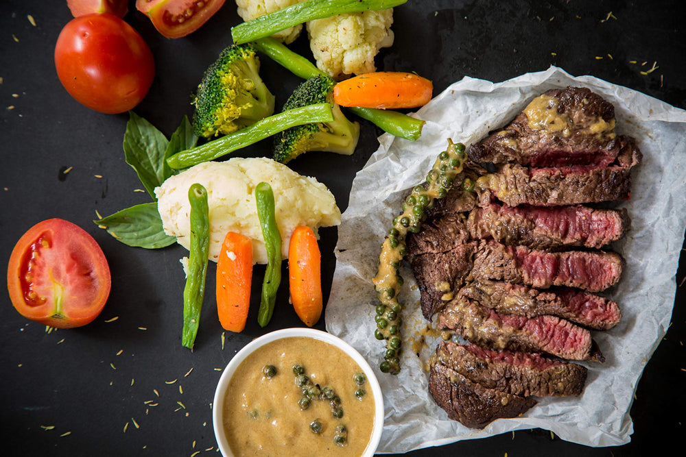 June Moon Spice Company sprinkled on grilled steak slice, enhancing crust and savory appeal