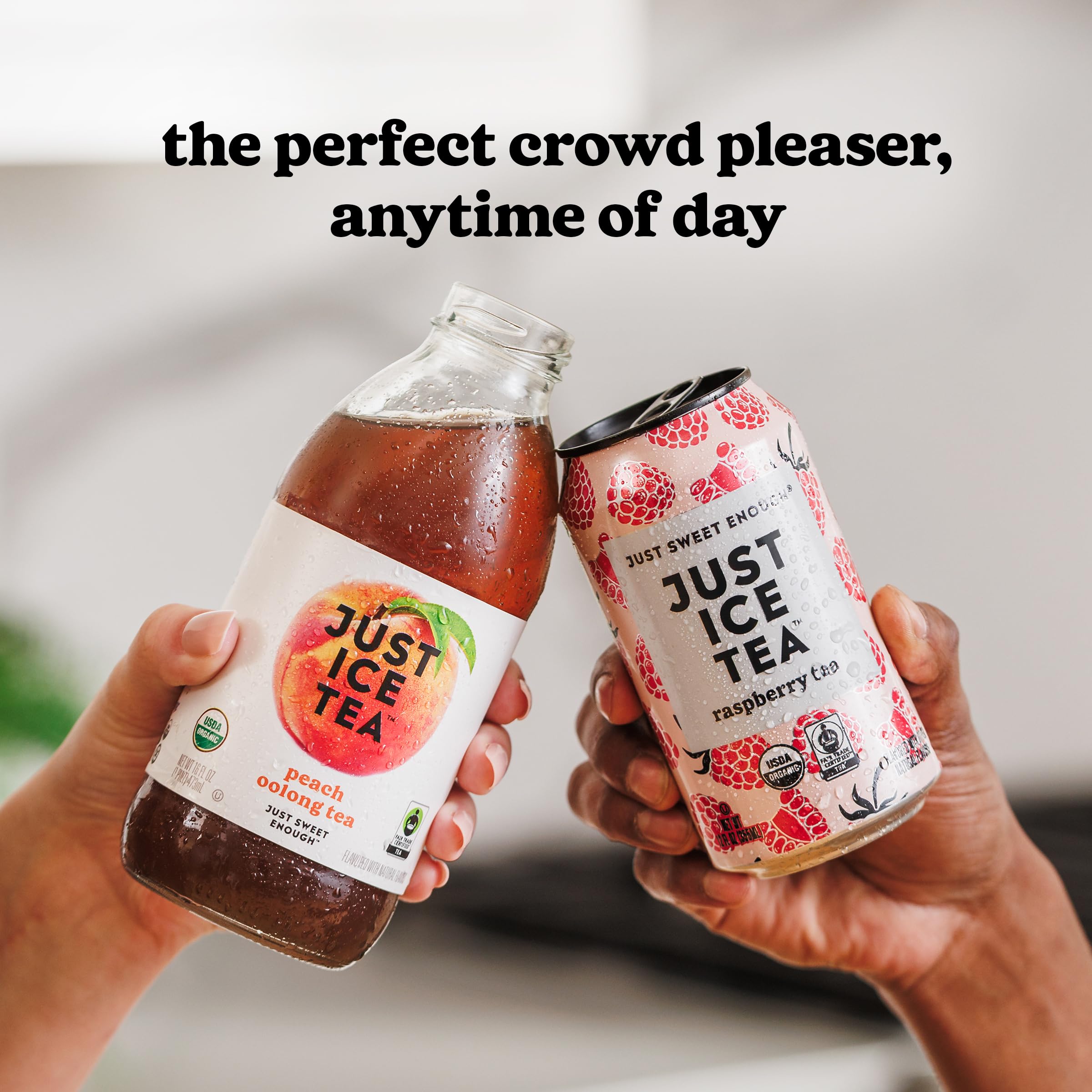 Just Ice Tea held by hand beside a soda can for scale, showing compact 12oz serving