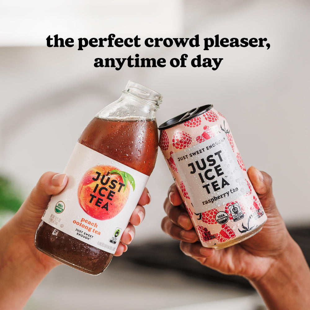 Just Ice Tea held by hand beside a soda can for scale, showing compact 12oz serving