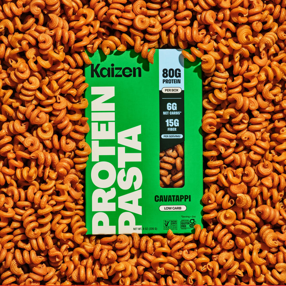 Kaizen pasta beside measuring cup to show serving size and protein content per portion