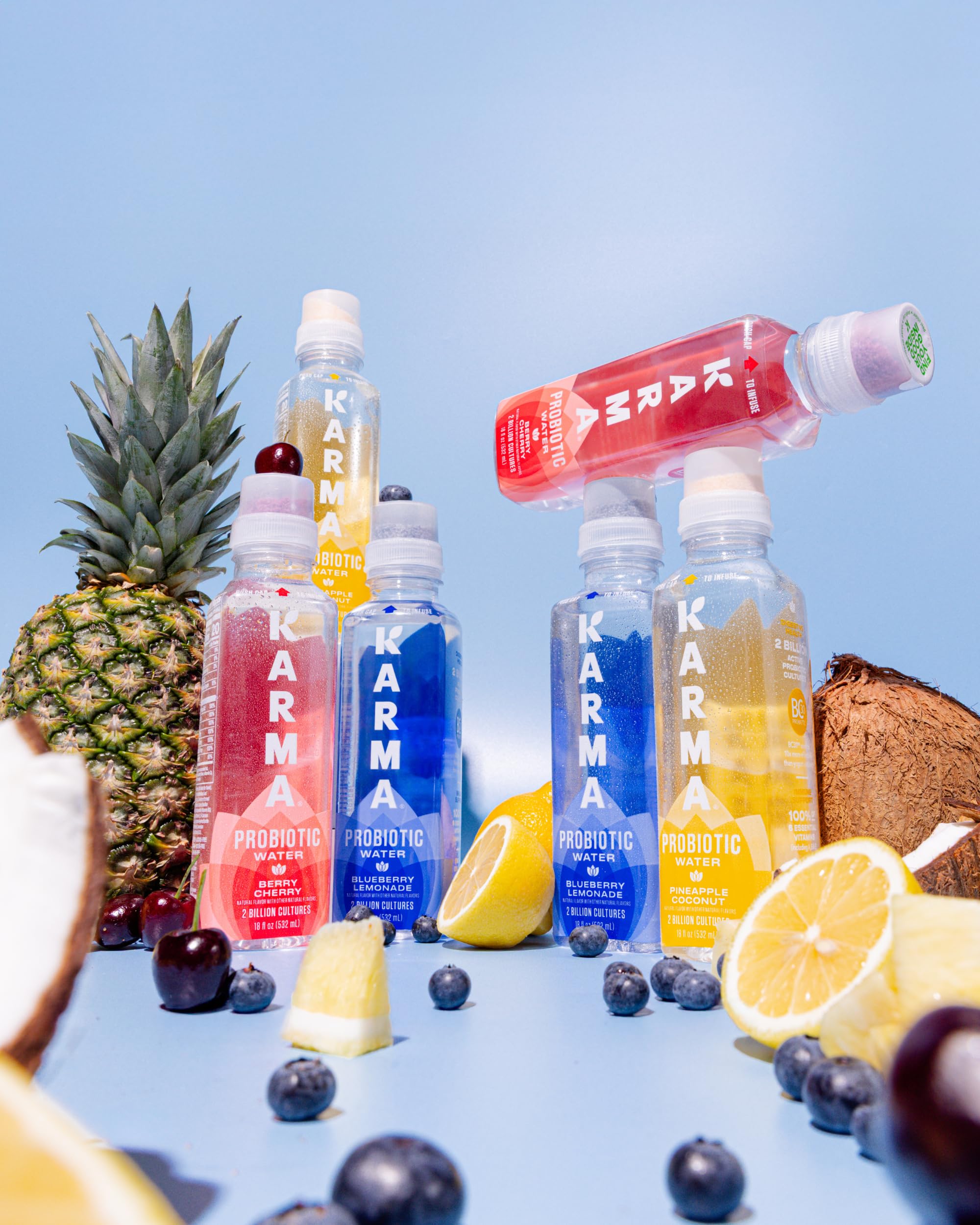 Karma bottle beside pineapple and coconut to show natural flavor inspiration and taste appeal