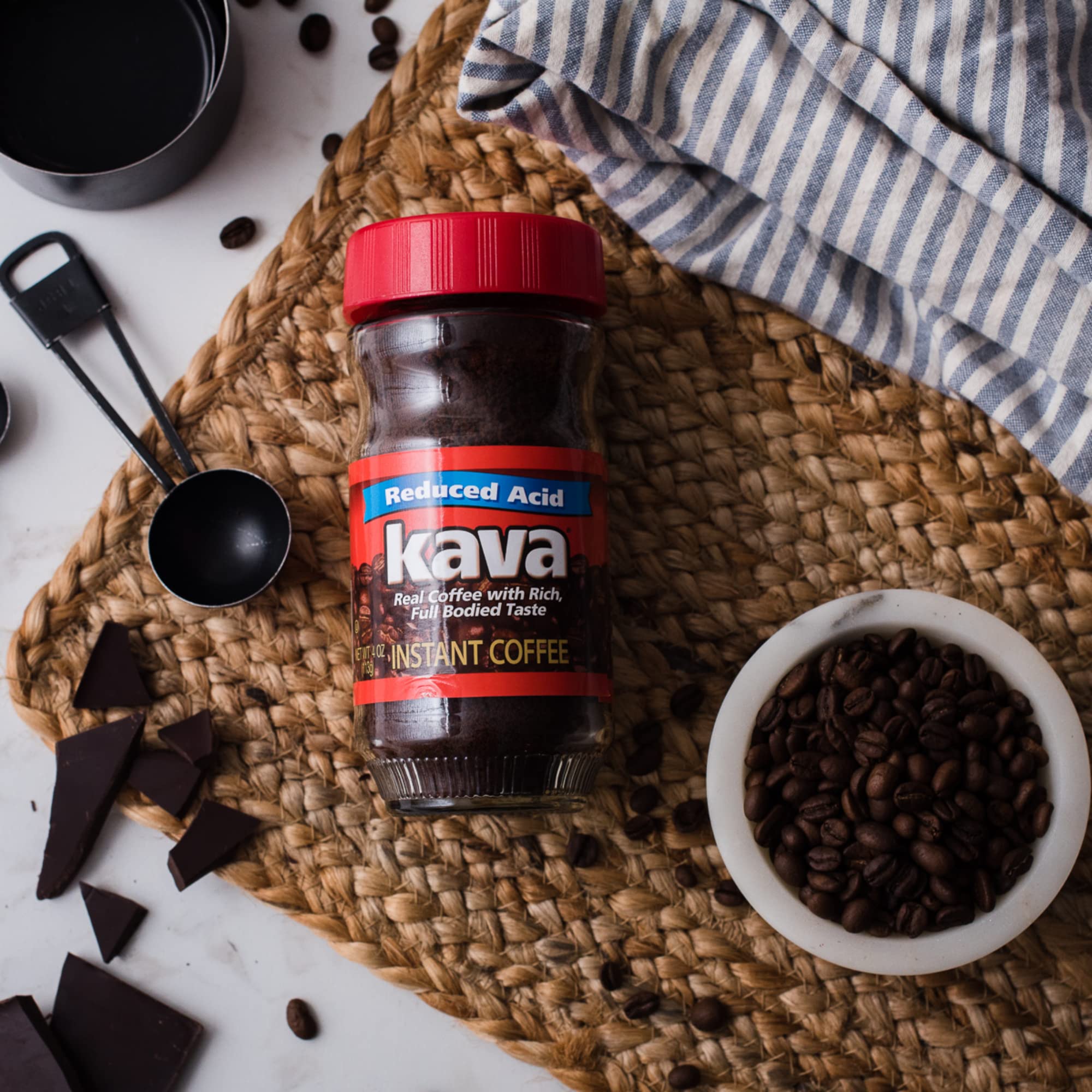 Kava scoop stirring instant coffee into a cup showing quick dissolution and easy preparation