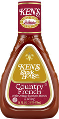Ken's Steak House pouring dressing on mixed salad for added flavor