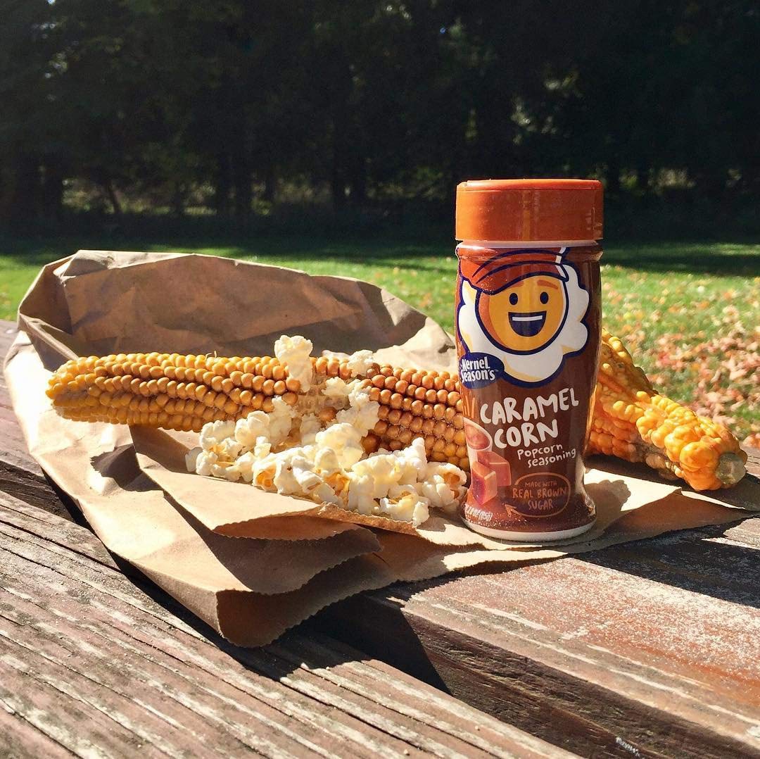 Kernel Season's caramel on a party table conveying simple, shareable snack enhancement