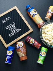 Kernel Season's seasoning sprinkled on popcorn adding bold flavor