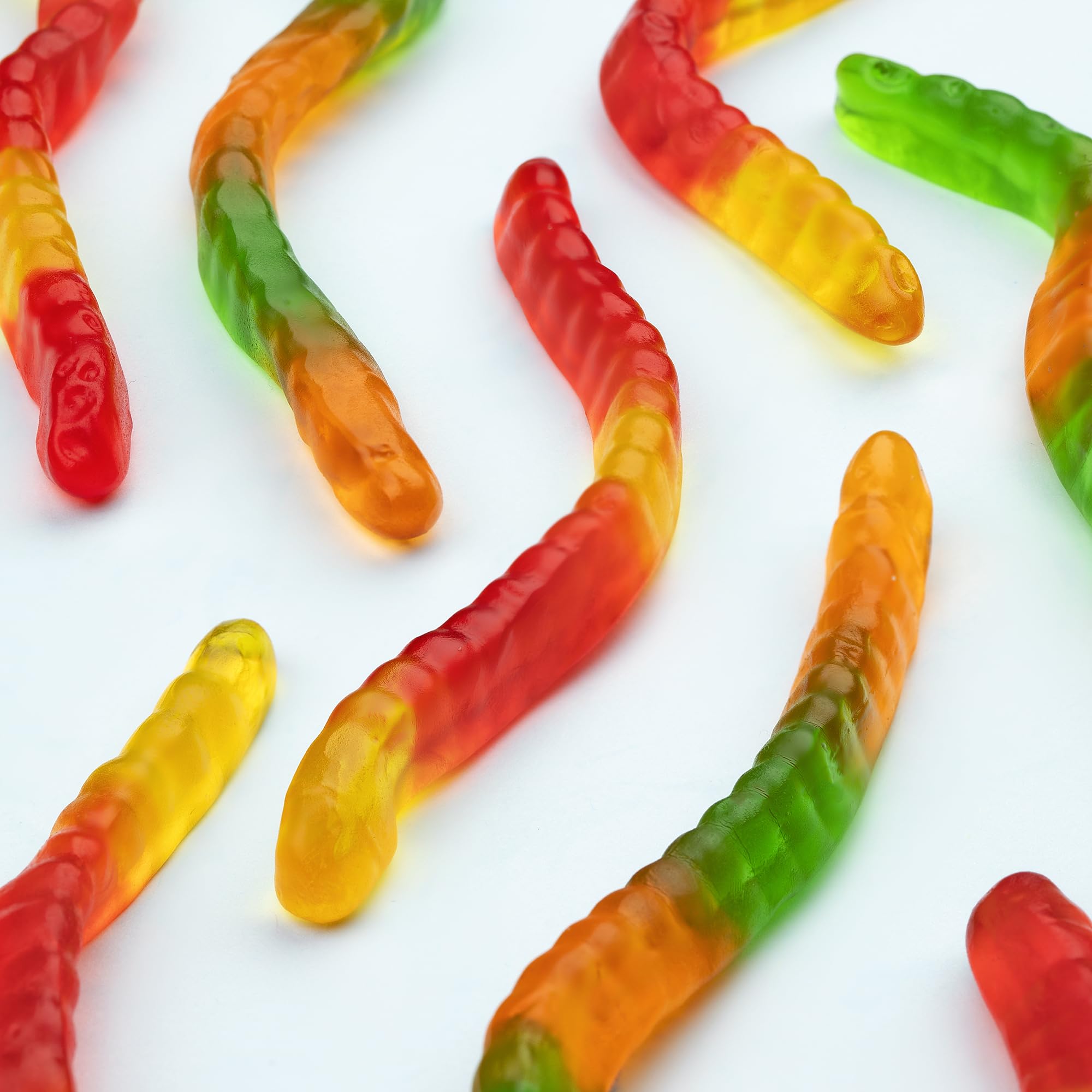 Kervan scattered pile of mixed-color gummy worms showing variety and appeal
