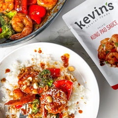 Kevin's Natural Foods Orange simmer sauce bottle closeup highlighting bright citrus flavor